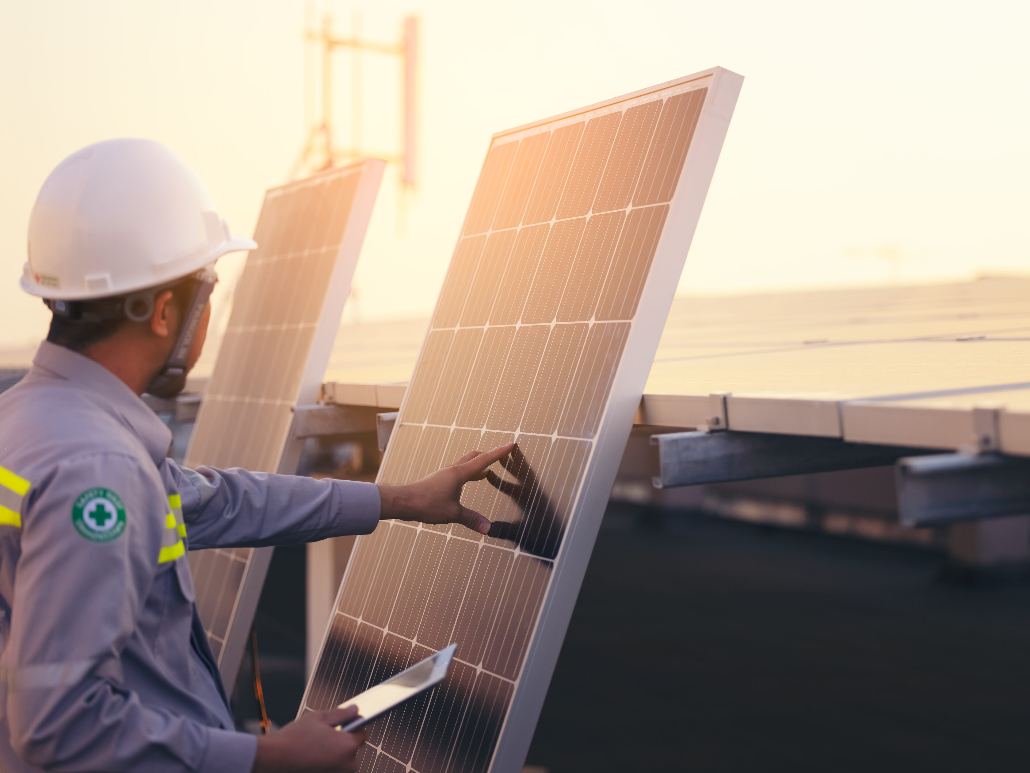 Engineer solar photovoltaic panels station checks with tablet co